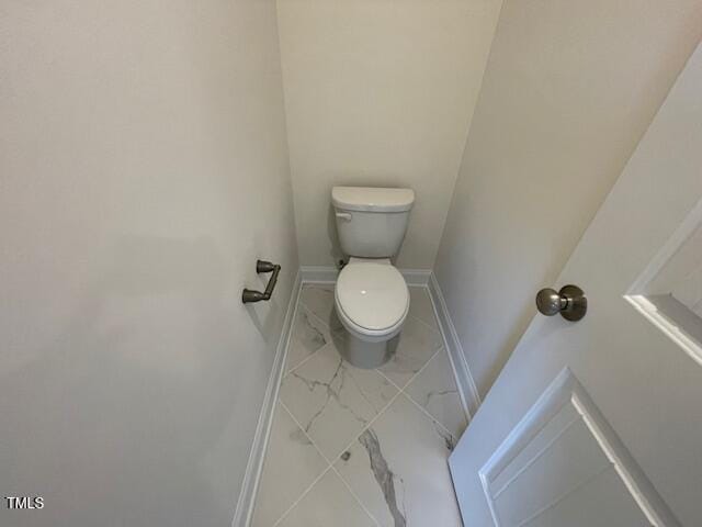 85 N Stagecoach Dr, Wendell, NC 27591 - bathroom featuring marble look tiles, toilet, and baseboards