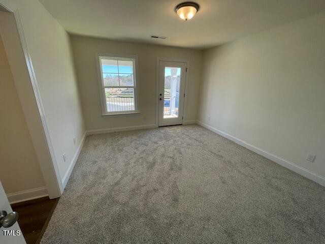 85 N Stagecoach Dr, Wendell, NC 27591 - spare room featuring baseboards and carpet flooring
