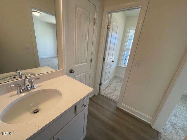 85 N Stagecoach Dr, Wendell, NC 27591 - bathroom featuring wood finished floors, vanity, and baseboards