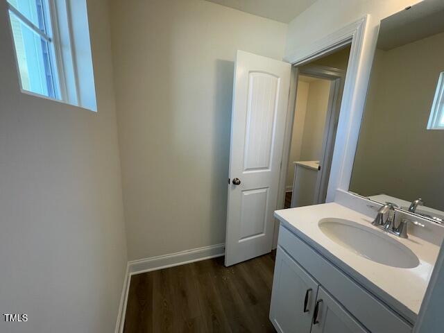 85 N Stagecoach Dr, Wendell, NC 27591 - bathroom featuring wood finished floors, vanity, and baseboards