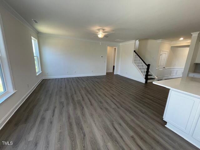 85 N Stagecoach Dr, Wendell, NC 27591 - unfurnished living room featuring stairway, crown molding, plenty of natural light, ceiling fan, and dark wood-style floors