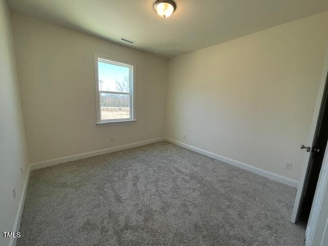 85 N Stagecoach Dr, Wendell, NC 27591 - carpeted spare room featuring baseboards