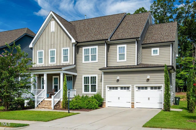 view of front of property with covered porch, a garage, and a front lawn