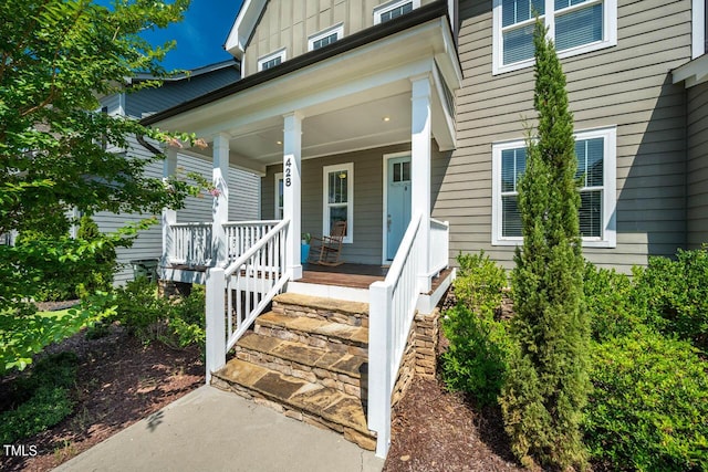 view of exterior entry with covered porch