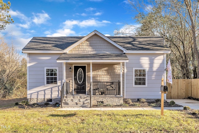 bungalow-style home featuring a front lawn