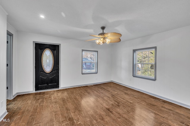 foyer entrance featuring hardwood / wood-style floors, ceiling fan, and a textured ceiling