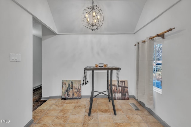 dining area featuring lofted ceiling and a chandelier