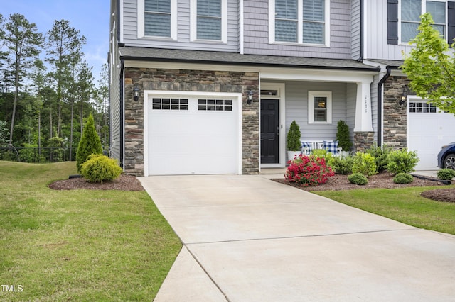 view of front of home featuring a garage, covered porch, and a front lawn