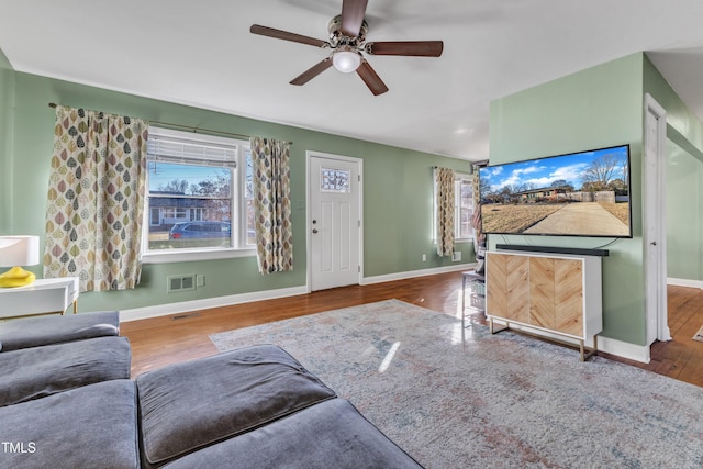 unfurnished living room with hardwood / wood-style flooring and ceiling fan