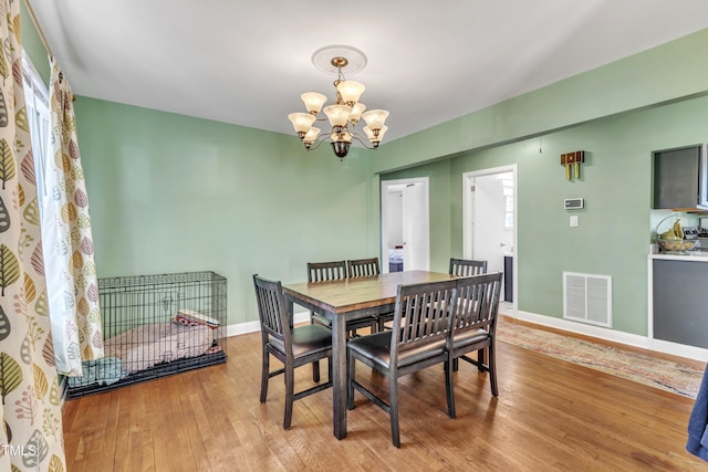 dining room featuring a chandelier and light wood-type flooring