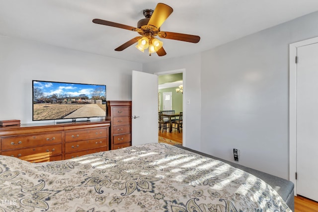 bedroom with light hardwood / wood-style flooring and ceiling fan