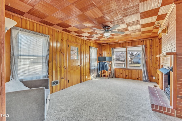 misc room with carpet, wood ceiling, plenty of natural light, and ceiling fan