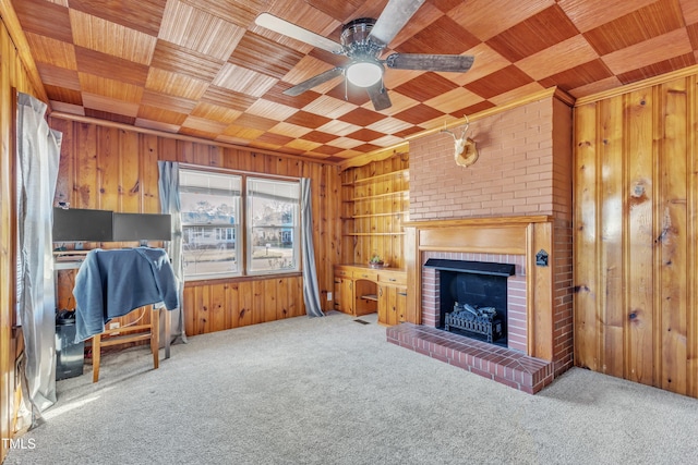 unfurnished living room featuring carpet, wood ceiling, and a fireplace