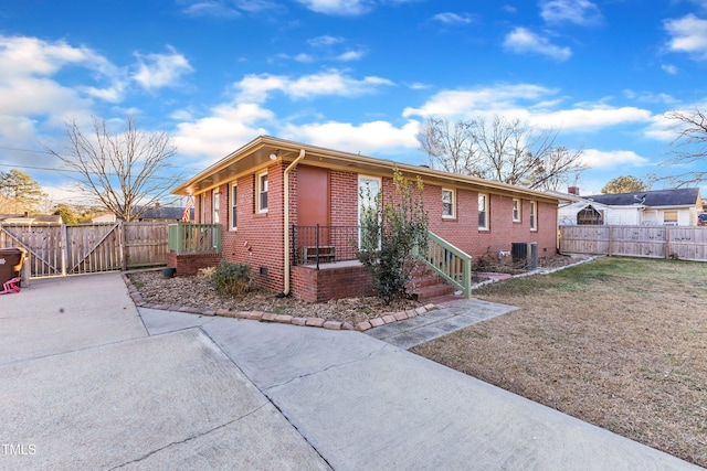 ranch-style house with a front lawn and cooling unit