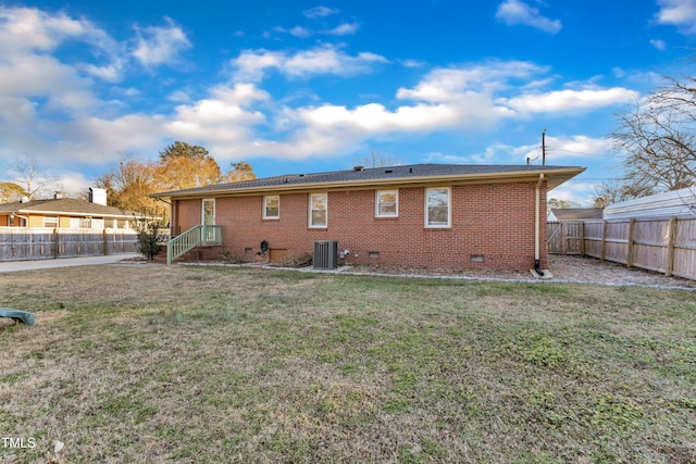 back of house with a lawn and central AC