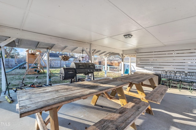 view of patio with a playground and grilling area