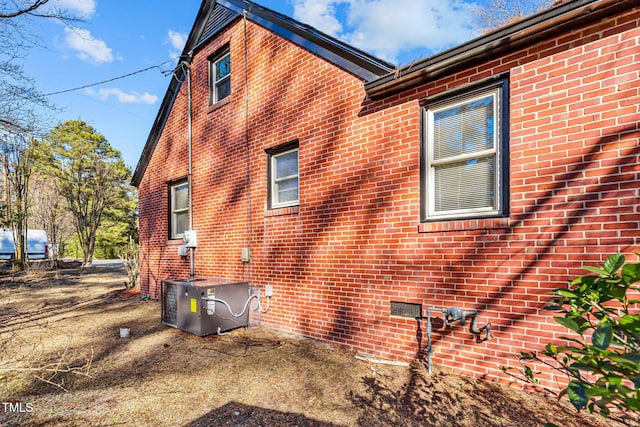 view of side of home featuring a patio and central AC unit