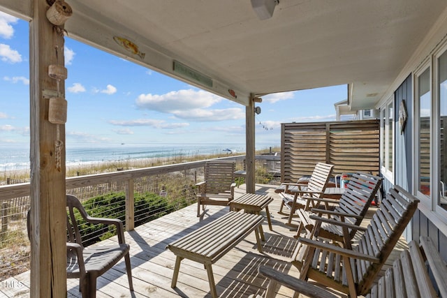 exterior space with a water view and a view of the beach