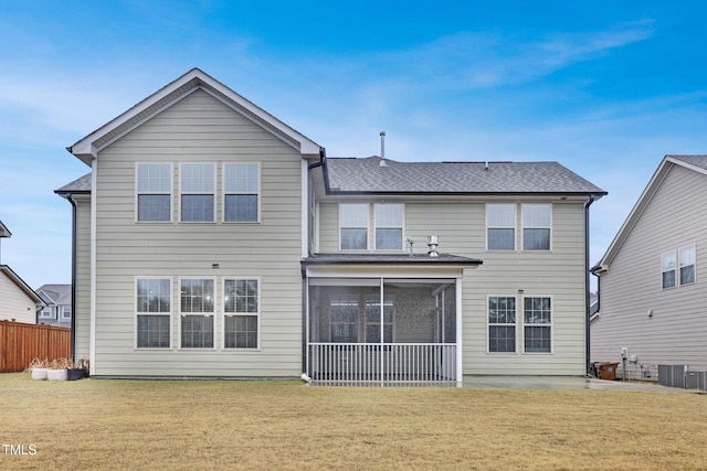 back of property with cooling unit, a sunroom, a lawn, and fence