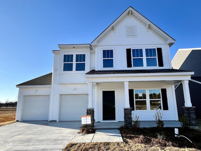 view of front of house featuring a porch and a garage