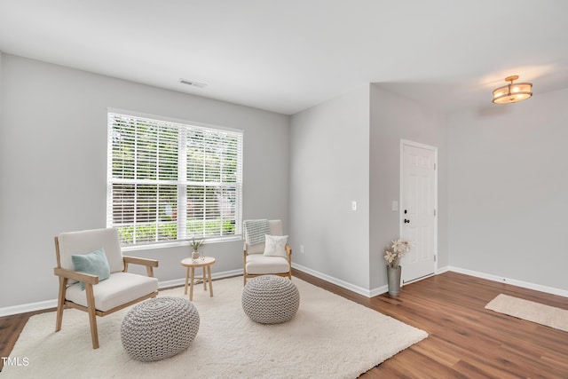 sitting room with wood-type flooring