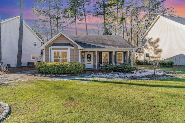 view of front of home featuring a yard and cooling unit