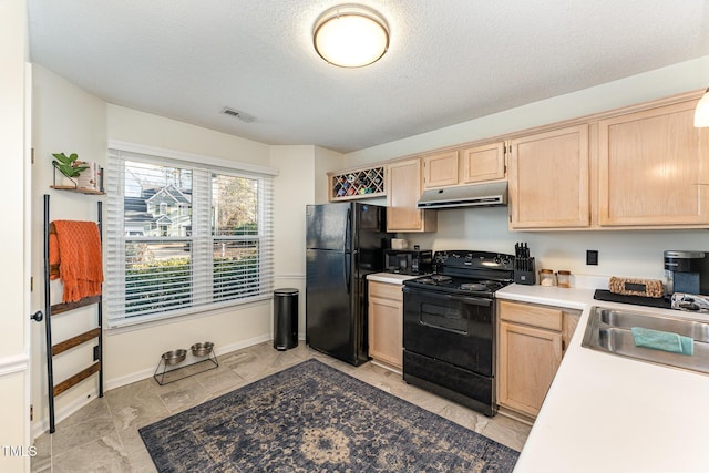 kitchen featuring light brown cabinets, black appliances, a textured ceiling, and sink