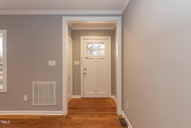 entryway featuring crown molding and light hardwood / wood-style flooring