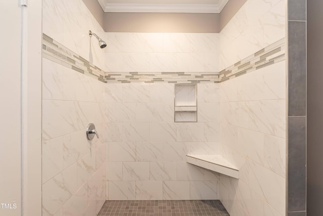 bathroom featuring a tile shower and crown molding