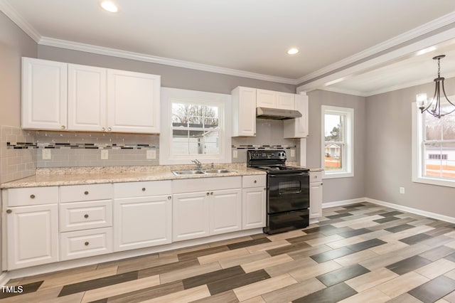 kitchen featuring electric range, sink, hanging light fixtures, a chandelier, and white cabinets