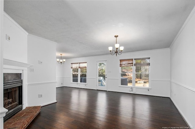 unfurnished living room with a notable chandelier, crown molding, and dark wood-type flooring