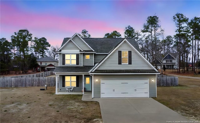 view of front of home featuring covered porch and a garage