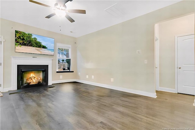 unfurnished living room with wood-type flooring and ceiling fan