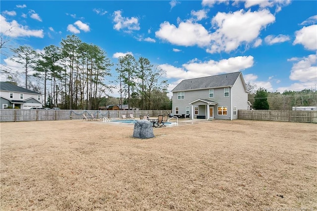 back of property featuring a fenced in pool and a patio