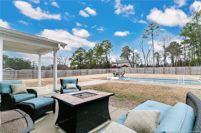 view of patio featuring a fire pit and a fenced in pool