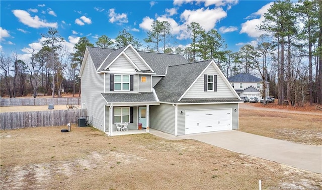 view of front of home with a garage, covered porch, and central AC