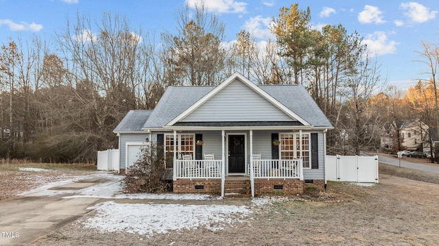 view of front of home featuring a garage, roof with shingles, a porch, and crawl space