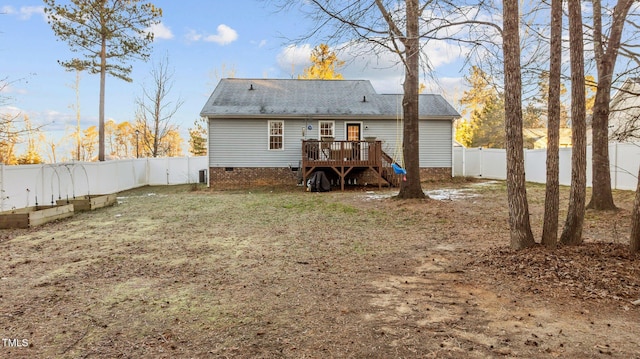 back of property with crawl space, a fenced backyard, and a deck