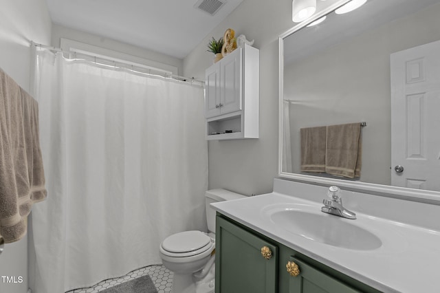 bathroom featuring toilet, visible vents, and vanity