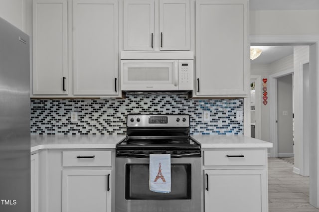 kitchen featuring appliances with stainless steel finishes, light countertops, and tasteful backsplash