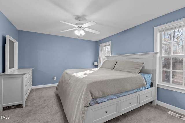 bedroom featuring light colored carpet, visible vents, and baseboards