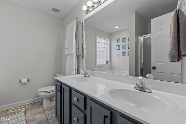 bathroom with toilet, visible vents, and a sink