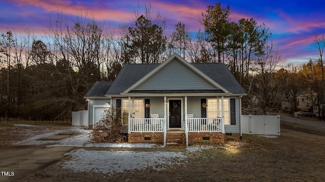 view of front of house with roof with shingles, a porch, an attached garage, crawl space, and driveway