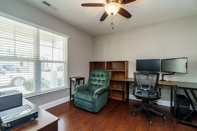 home office with ceiling fan and dark hardwood / wood-style floors