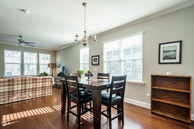 dining space featuring ceiling fan with notable chandelier, plenty of natural light, crown molding, and dark hardwood / wood-style floors