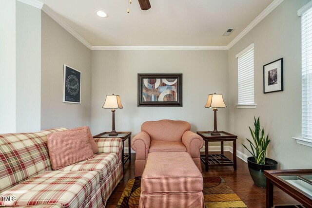 living room featuring dark wood-type flooring, ceiling fan, and ornamental molding