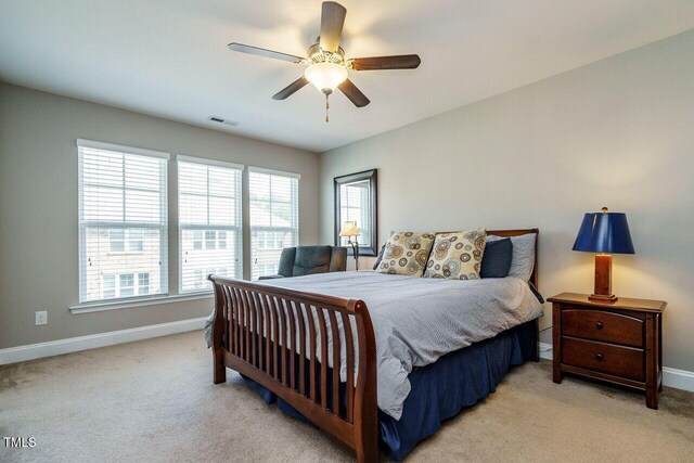 bedroom with ceiling fan and light colored carpet