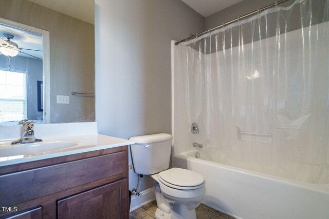 full bathroom with shower / bath combination with curtain, toilet, tile patterned floors, vanity, and ceiling fan