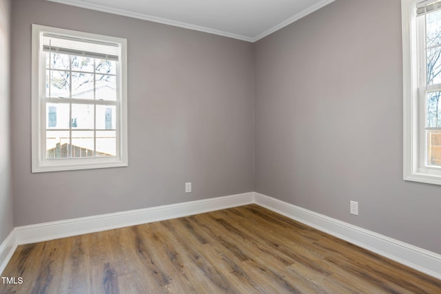 empty room with ornamental molding and hardwood / wood-style floors