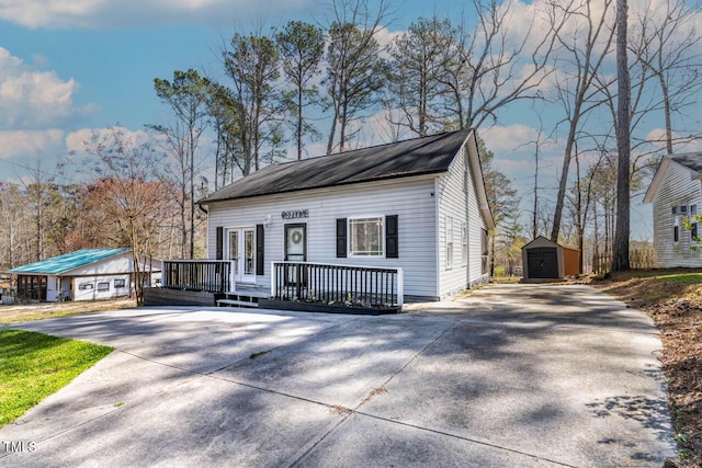 view of front of home featuring a storage unit and a deck